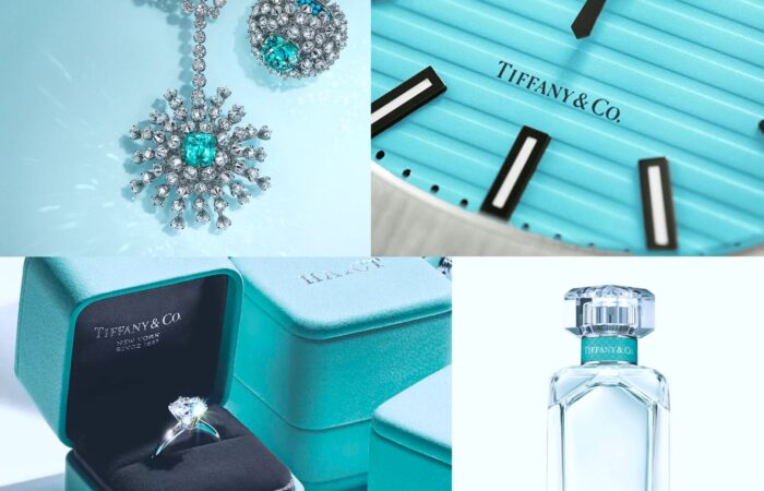 This image is a collage of four photos, each featuring products from Tiffany & Co., all set against a pale blue background that is signature to the brand: Top left: An elegant necklace and earring set with a prominent snowflake design, featuring diamonds and a central blue gemstone, possibly a turquoise or aquamarine, displayed on a light surface. Top right: A close-up of a wristwatch face with the Tiffany & Co. logo. The watch has a ridged blue face, silver casing, and black hands and hour markers. Bottom left: A collection of Tiffany & Co. boxes in their distinctive blue color. One box is open, revealing a classic solitaire engagement ring with a diamond set in a silver band. Bottom right: A clear glass perfume bottle with a faceted cap and a pale blue label indicating it is Tiffany & Co. Eau de Parfum, along with the size of the bottle (2.5 FL OZ or 75 ml). The collage showcases a range of luxury products from the brand, known for its fine jewelry and distinctive blue packaging.